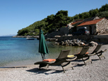 Pebble beach in the bay in front of the five star luxury villa on the island of Korcula in Croatia