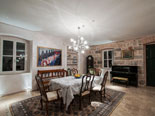 Dining area with a piano in the background at the exclusive rental villa in Dubrovnik
