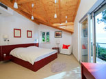 Bedroom in the modern Dalmatian seafront villa with pool on Brac Island in Split region