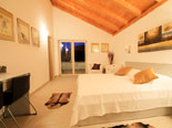 Bedroom in the modern Dalmatian seafront villa with pool on Brac Island in Split region