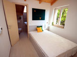 Bedroom in the modern Dalmatian seafront villa with pool on Brac Island in Split region