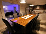 Dining table with kitchen in the background in this seafront Dalmatian luxury villa