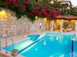 The swimming pool sits on top of the upper terrace and is surrounded by colourful garden with palm trees, oleanders and cypress trees.