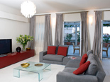 The living area is equipped with TV, modern sofas...