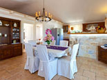 Dining room and kitchen in background in this seafront villa 