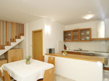 Dining room and the kitchen in the old Dalmatian stone villa in Sumartin on Island of Brač Croatia