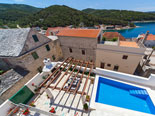 View on the pool and outside dining of the four star holiday villa for rent in Povlja on Brač Island in Dalmatia