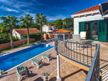 Outside palm tree rental villa with pool in Sumartin on Brač Island in Dalmatia in Croatia