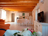 Dining room, living room and kitchen in background in holiday house for rent in Omiš