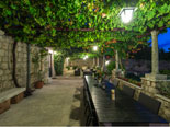 Courtyard dining and lounge area in this villa in Dubrovnik by night